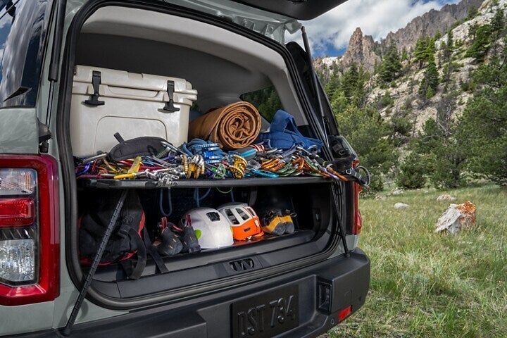 cargo space of an suv packed with camping gear